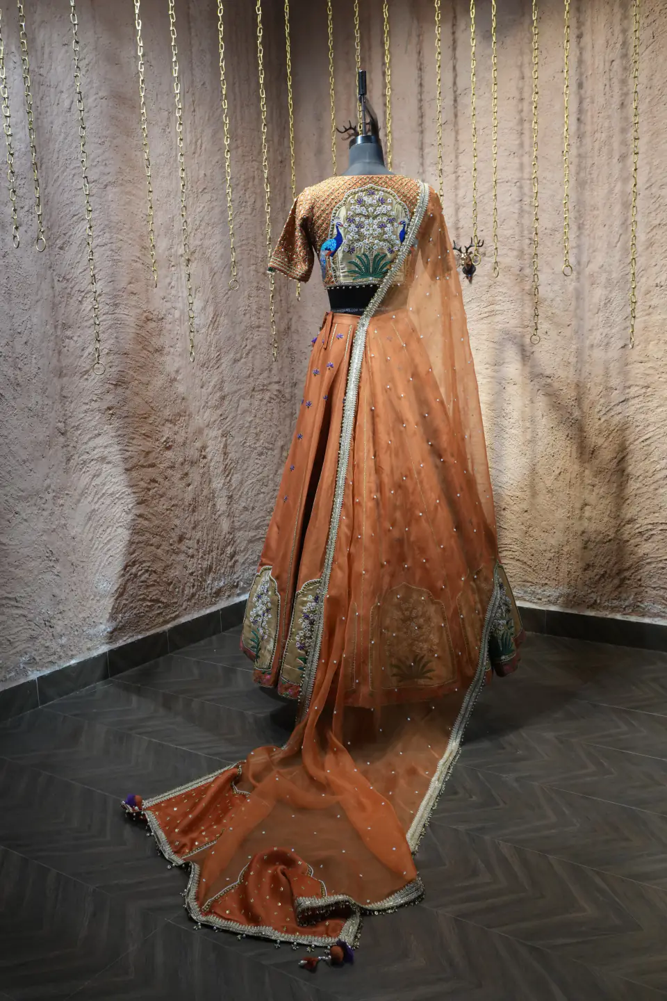 Rust Silk Lehenga with Mughal Arch Panels by Yukti Vohra — trailing dupatta, side