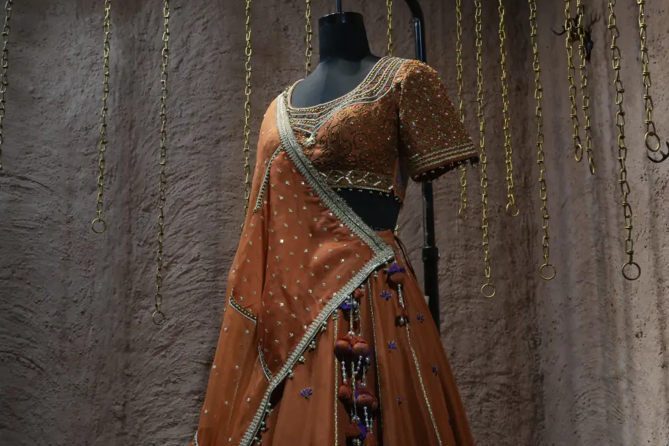 Rust Silk Lehenga with Mughal Arch Panels by Yukti Vohra — draped dupatta