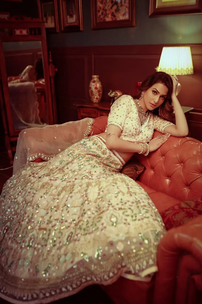 Bride in an embroidered ivory lehenga by Yukti Vohra